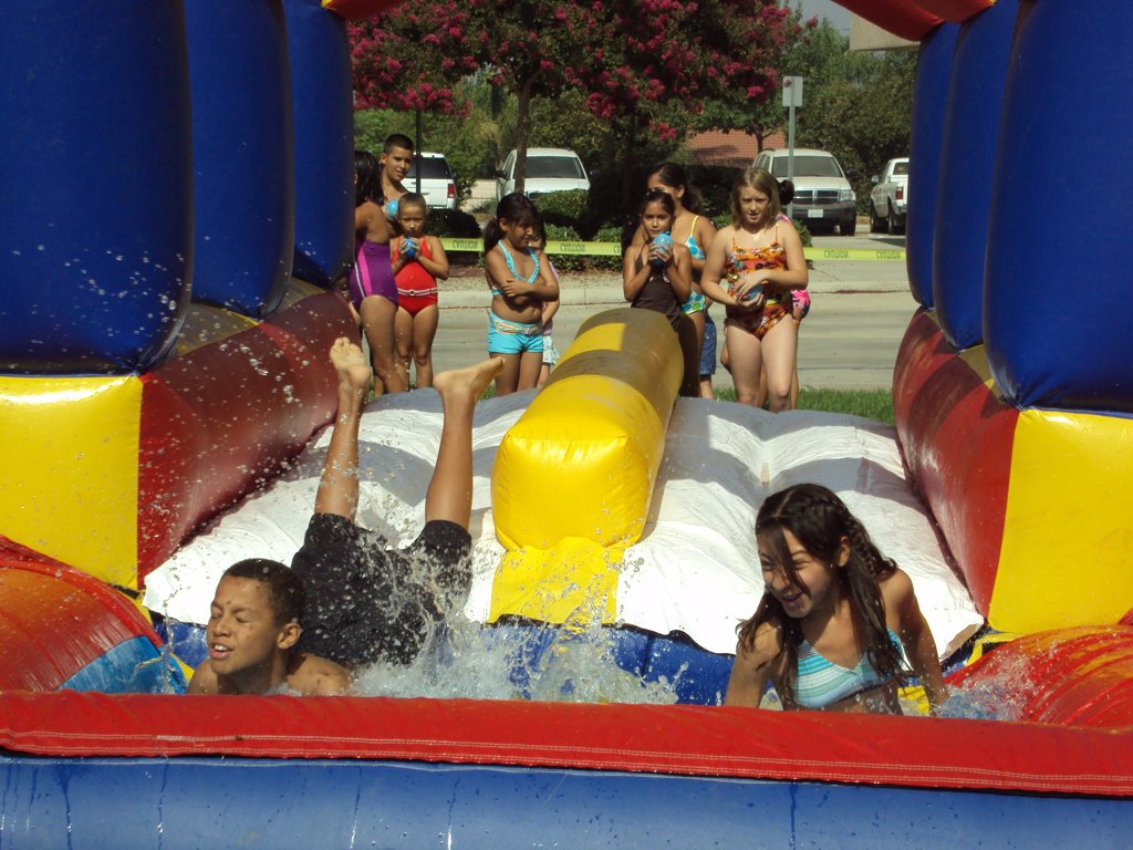 Youth Enrichment Kids sliding a jumper