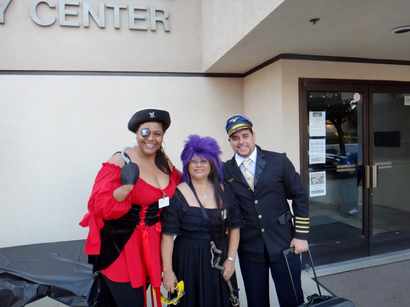Harvest Costume Ball Lady dressed as pirate, other lady dressed as witch, and guy dress as pilot for Costume Ball
