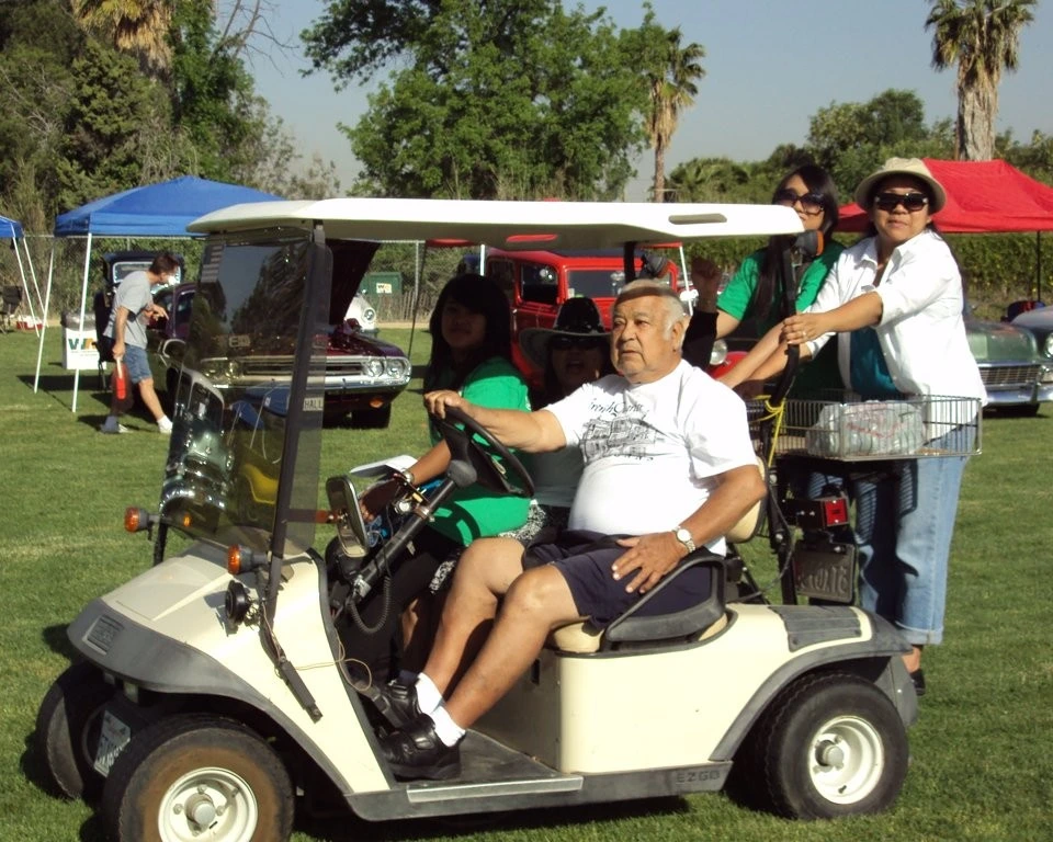 Volunteers getting a ride in a golf cart