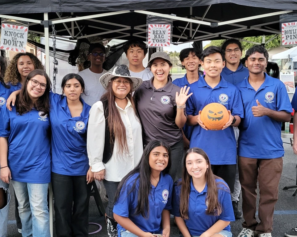 Volunteers smiling in Harvest Custome Ball